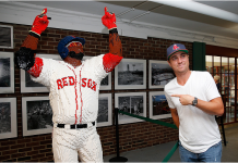 ICYMI: Red Sox Fan Justin Thomas Throws Out First Pitch at Fenway Justin Thomas poses with a statue of David Ortiz