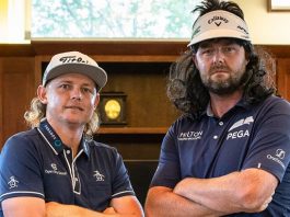 Marc Leishman, wearing a wig mullet, and Cameron Smith